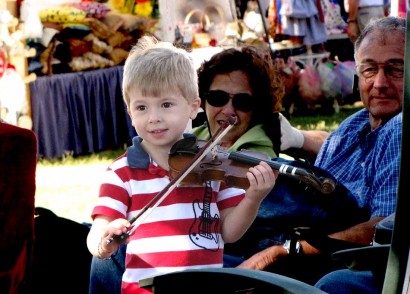 photo of young boy playing fiddle