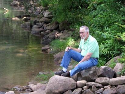 The Farmer by Elk River. picture on men sitting on rock
