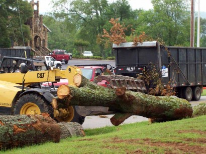 tornado-debris-removal tornado aftermath - removing tree from ditch